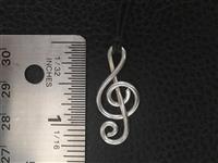 Thick Treble Clef Pendant, Sterling Silver hand bent and hammered, attached with an adjustable cotton cord. Option to upgrade to Sterling Silver rollo chain.
