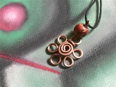 Thick hand bent copper wire pendant with beautiful wood bead accent. Hangs from an adjustable cotton cord.